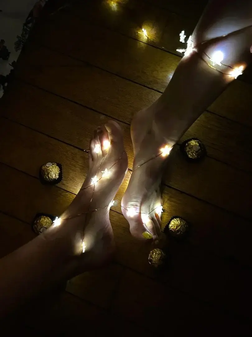 Some chocolates surrounding our feet. Do you want to eat some ?#feet #foot #feetlover #footlover #feetpics #footpics #fetichism #sisters #lights #christmas #chocolate #toes