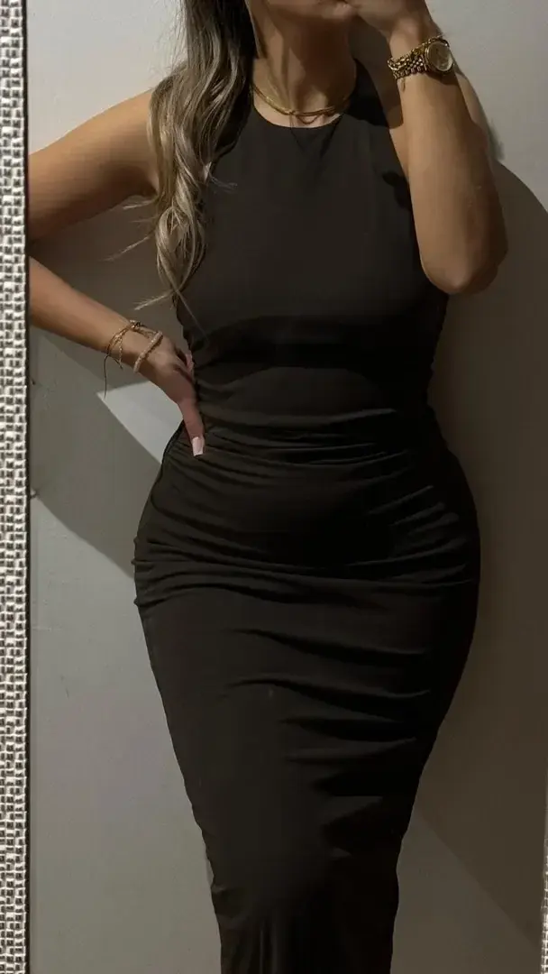 The dress hugs, the light flatters, and the rest is for your imagination. 🖤