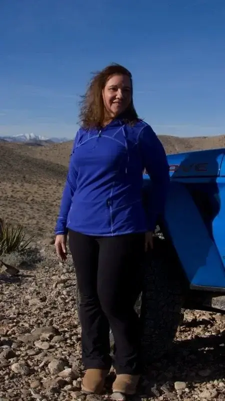 Blue skies, rocky roads, and me leaning into the adventure.